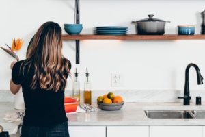 A woman prepping food in her modern kitchen