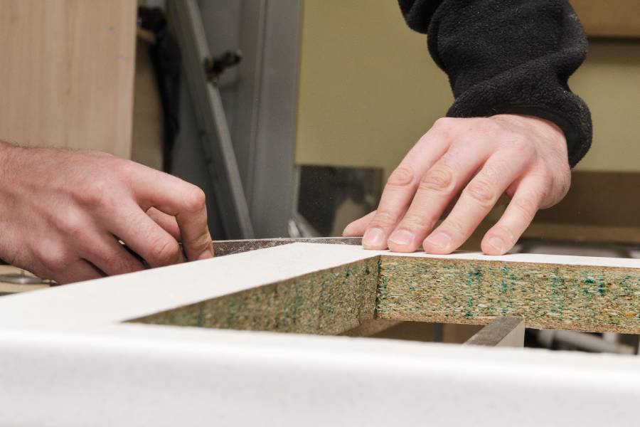Expert technician preparing countertop for marble and granite installation in Plantation