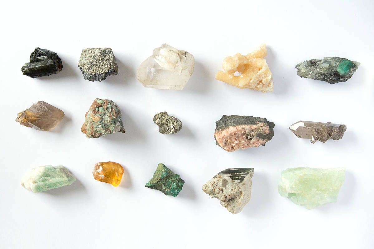 Colorful collection of minerals on a white table surface
